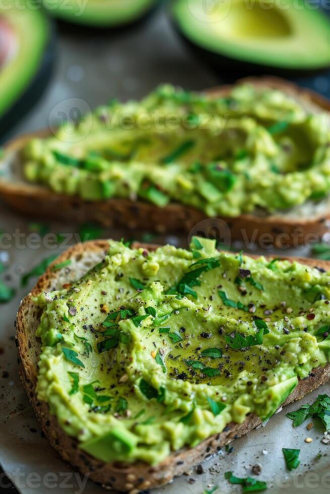 Fresh avocado hummus toast topped with herbs on whole grain bread photo