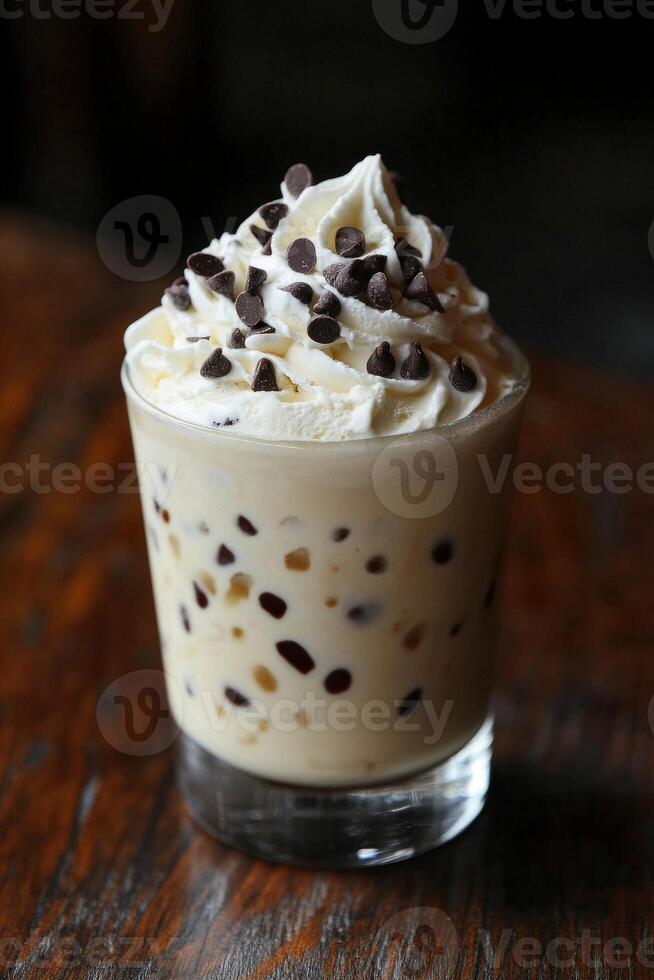 Refreshing ice cream drink topped with whipped cream and chocolate chips photo