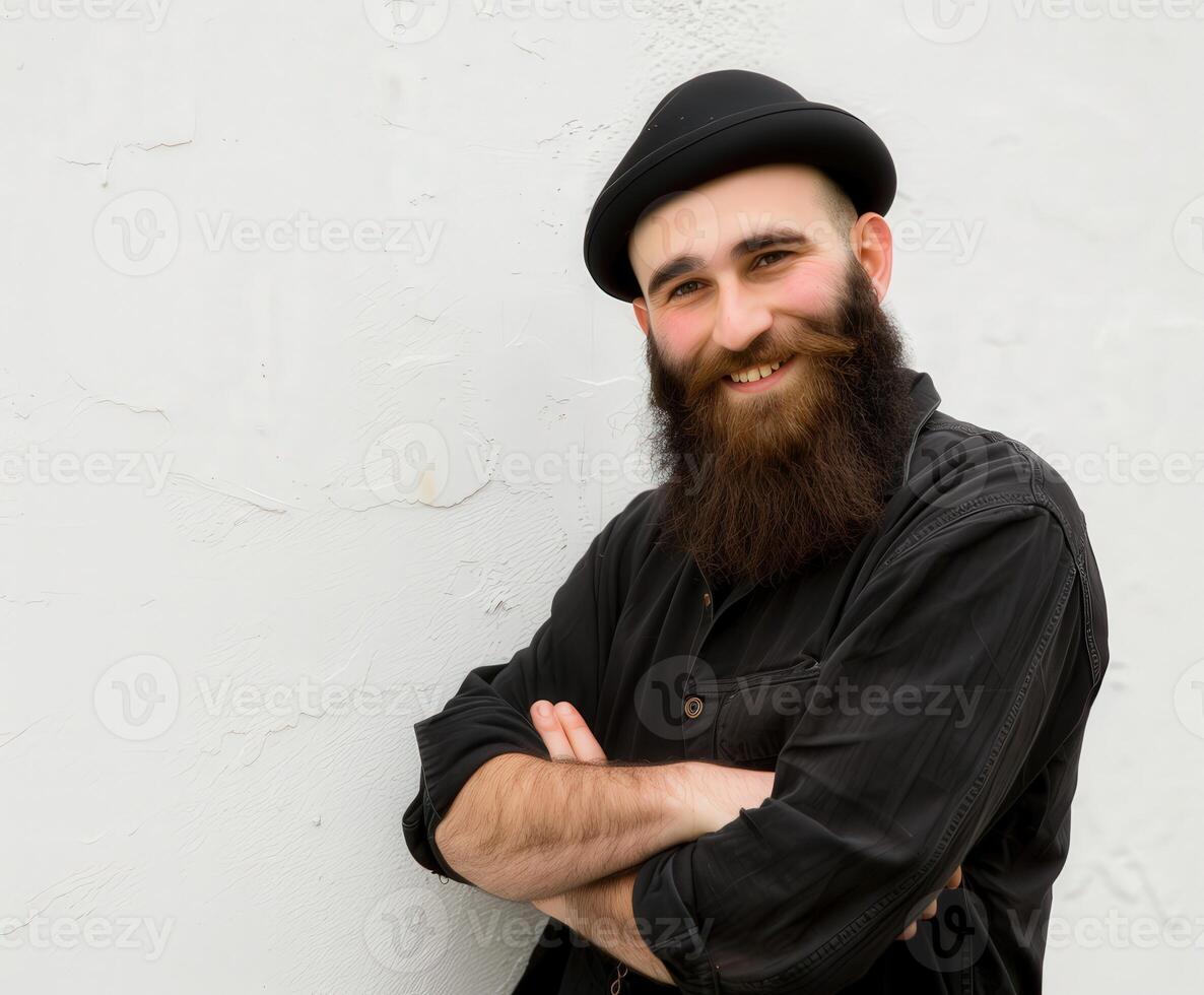 Smiling Muslim Man With a Beautiful Beard Posing Against a White Wall photo