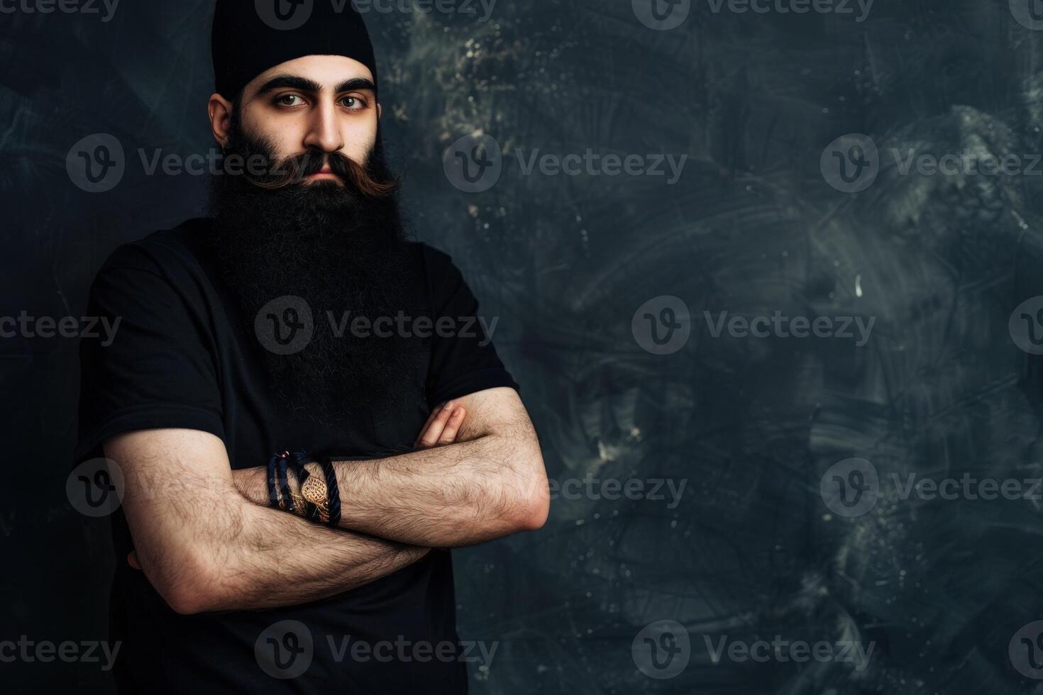 Muslim Man With a Long Beard Posing Confidently Against Dark Background photo