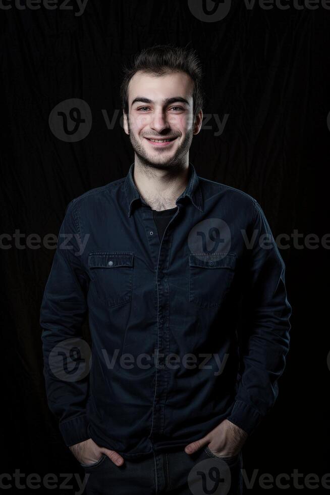Minimalistic Portrait of a Smiling Male Executive in a Dark Setting photo