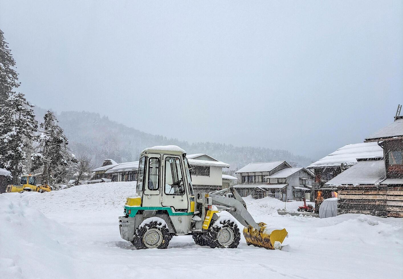 A tractor in snowy village. photo