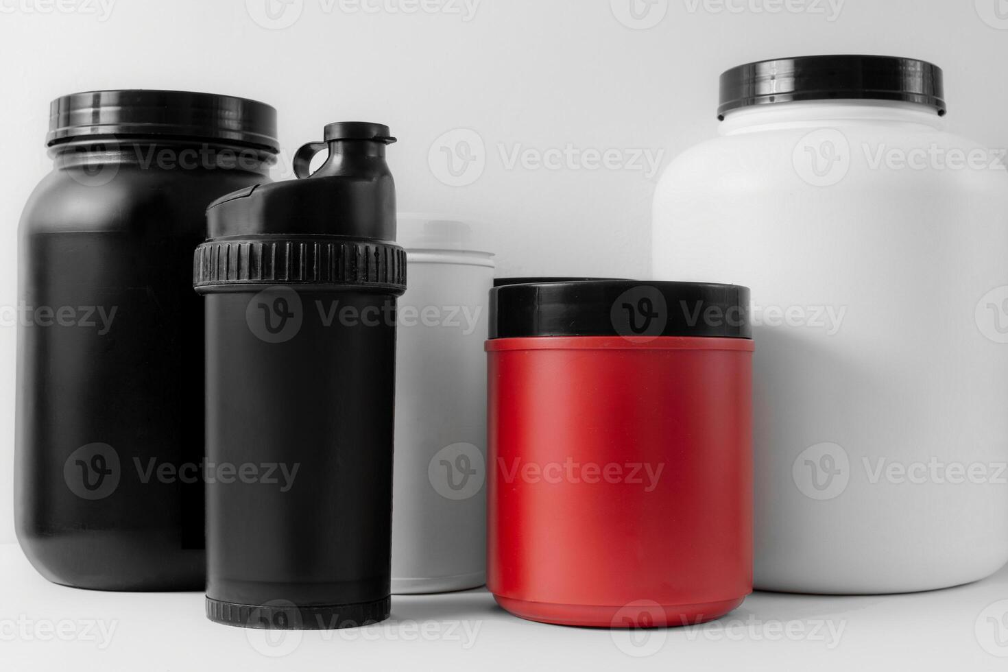 containers of weight gainers, protein and creatine on a white isolated background photo