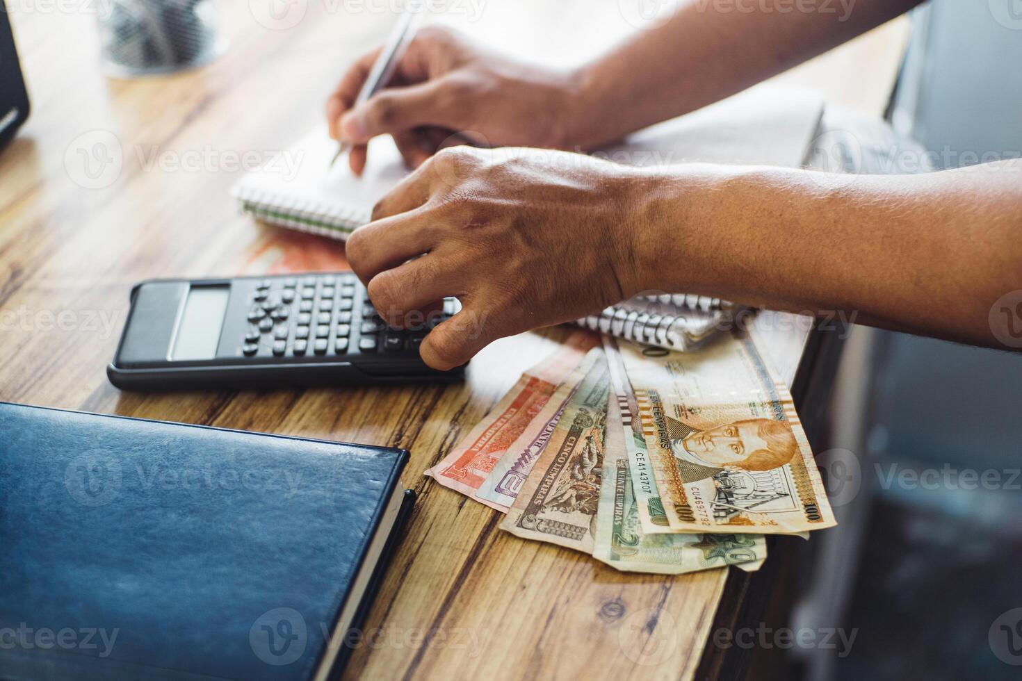 Unfocused person doing calculations on a calculator, budget and tax payment concept for entrepreneurs. photo