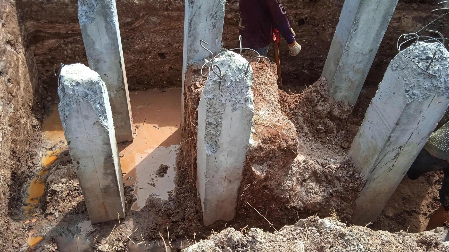 Concrete piles foundation under ground for a new building on construction site. photo