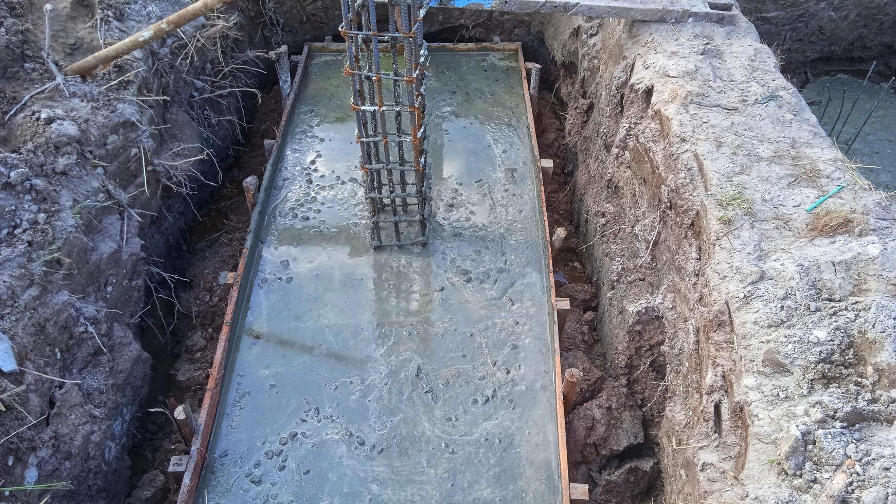 Foundation construction building site making reinforcement metal framework for pouring concrete photo