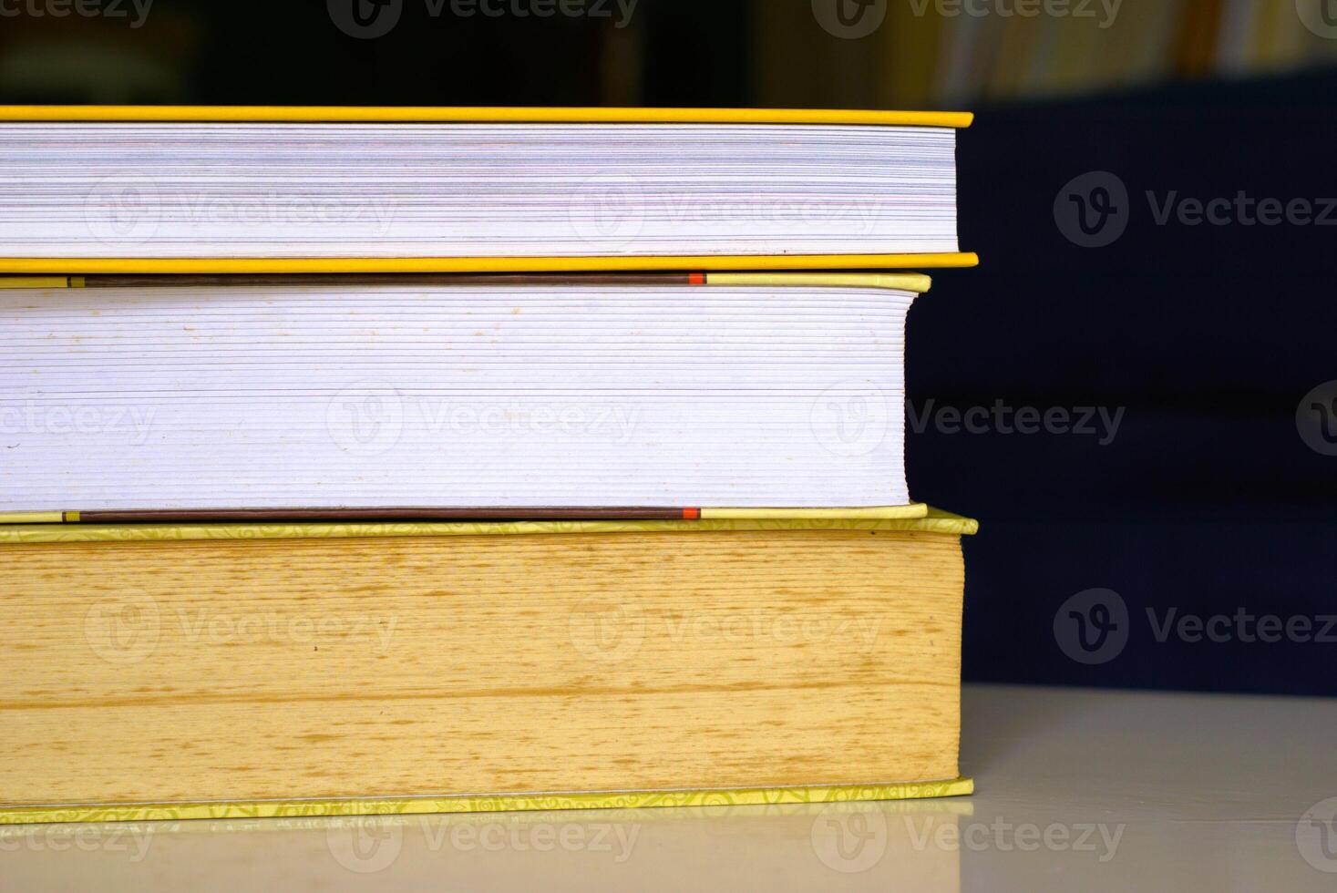 Close-up of stacked books on a desk photo