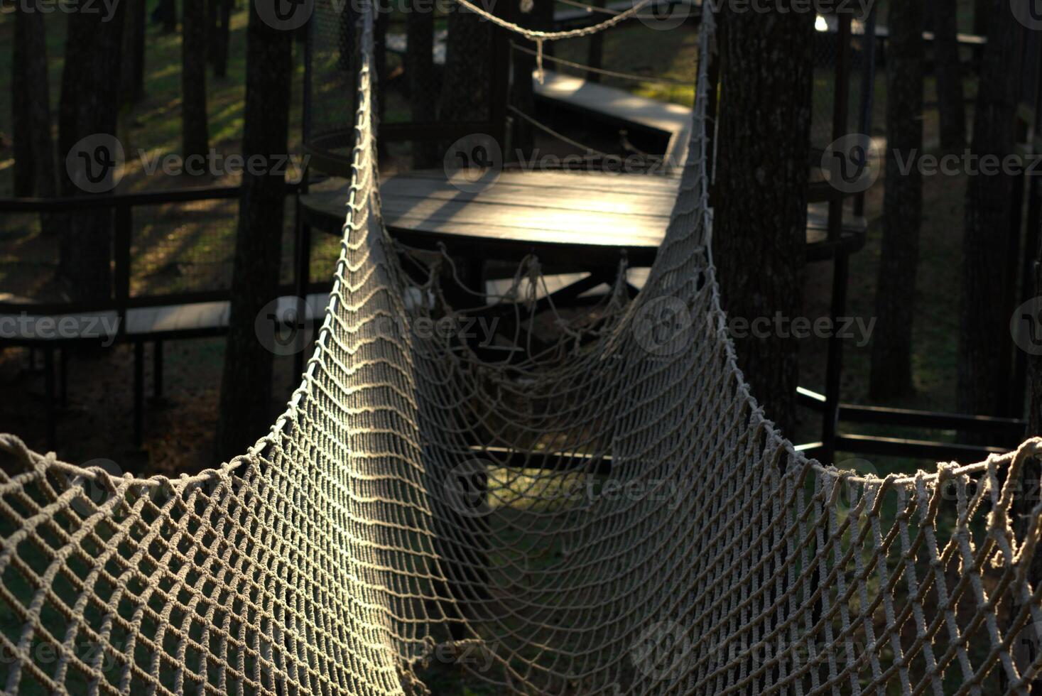 rope net bridge in the outdoor playground park photo