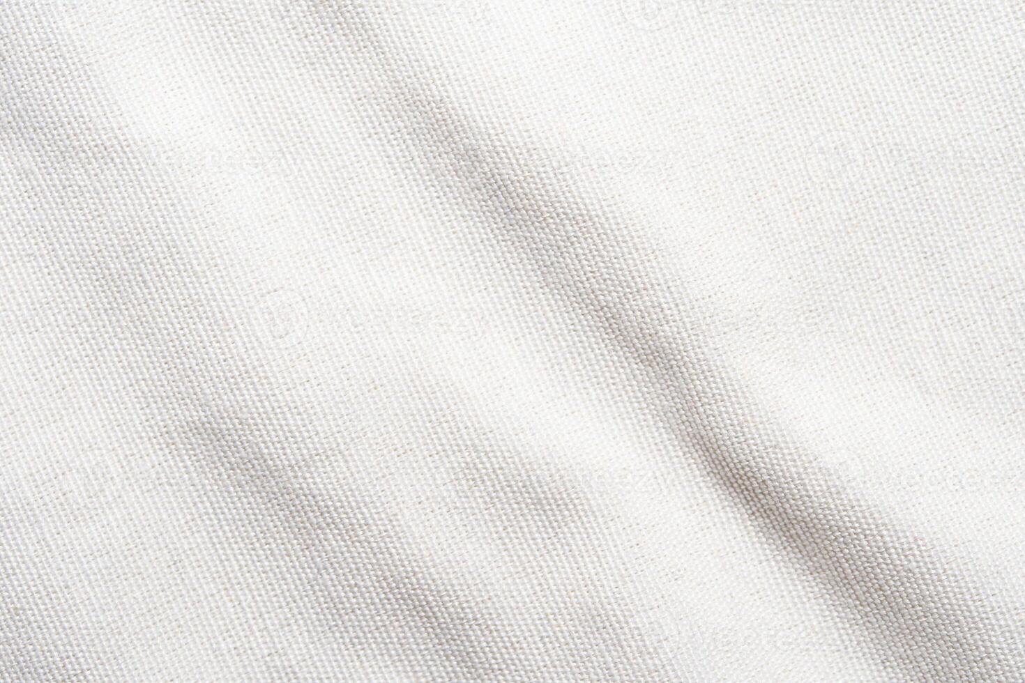 A soft, pure white fabric background with a delicate grid pattern. The texture is smooth and plain, resembling linen or cotton. Light creates subtle shadows on the surface. photo