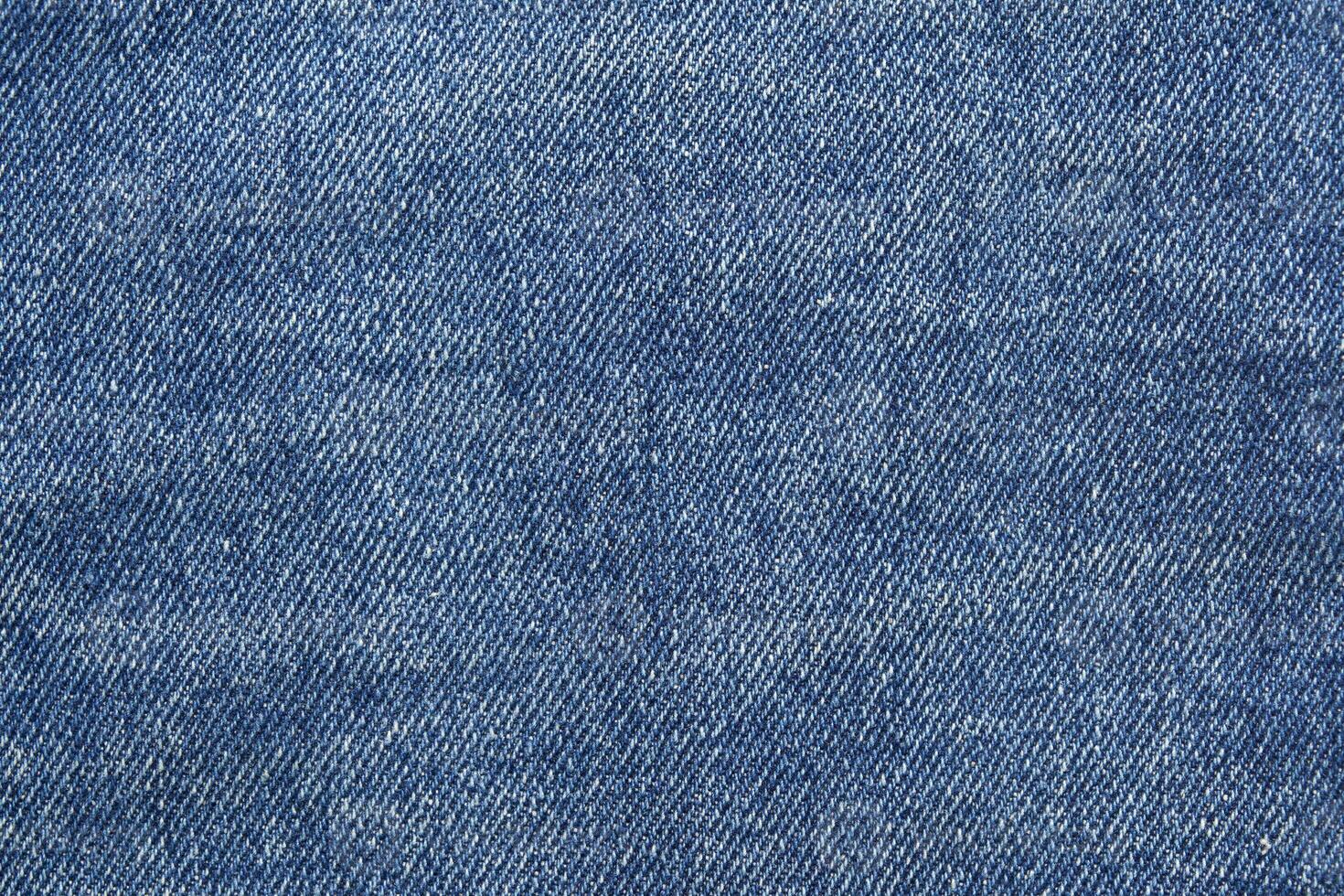 Blue jean texture. Blank denim cloth textile background. Soft fabric. Flat cotton surface. Grunge structure design. Dark navy material. Indigo vintage style. Copyspace photo