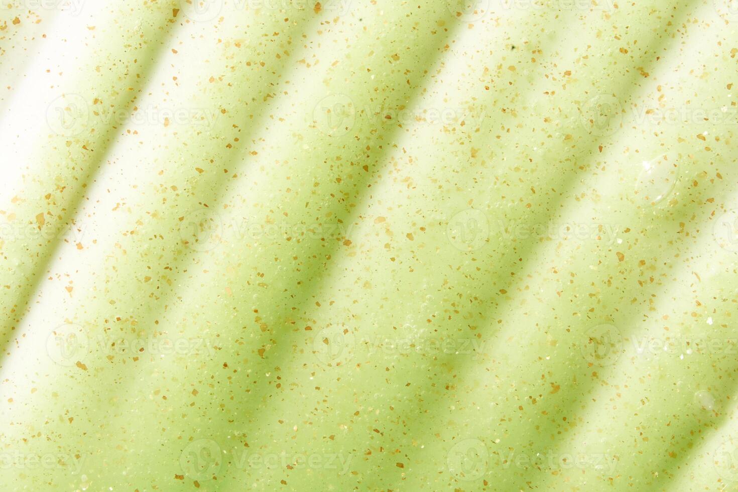 Cosmetic product background. Green scrub texture. Cleansing face emultion. Gel liquid peeling. Closeup pore cream. Abstract makeup lotion swatch. Beauty spa photo