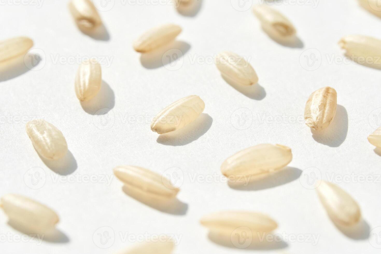 A top view captures the raw beauty of white basmati and brown rice grains. The macro closeup highlights their diverse textures, presenting a wholesome, nutritious food staple. Pattern photo