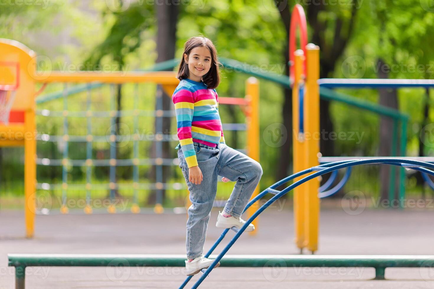 a little girl stand on the childrens stairs on the playground photo
