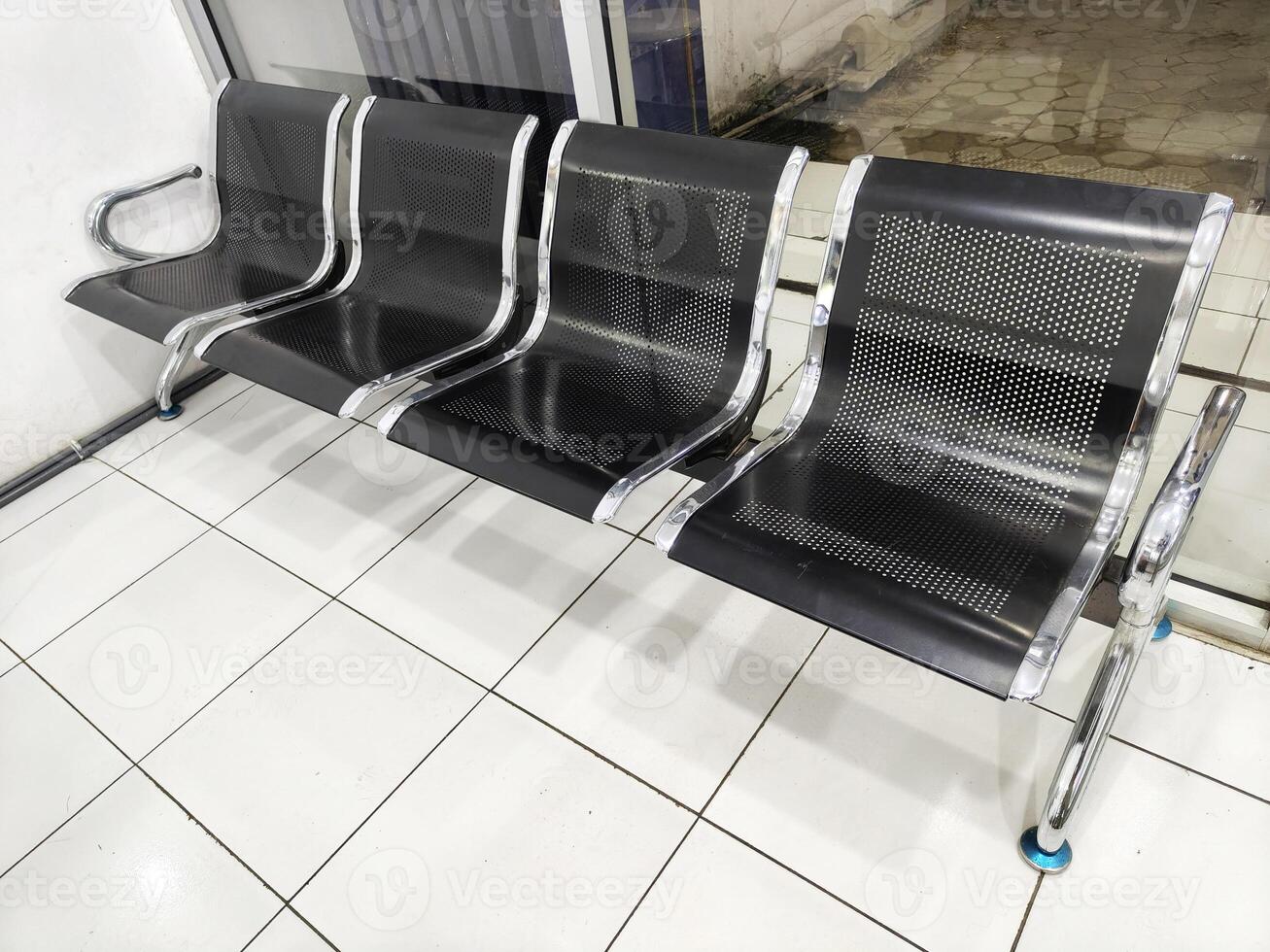 A row of chairs in a waiting room. clean and sleek environment. photo