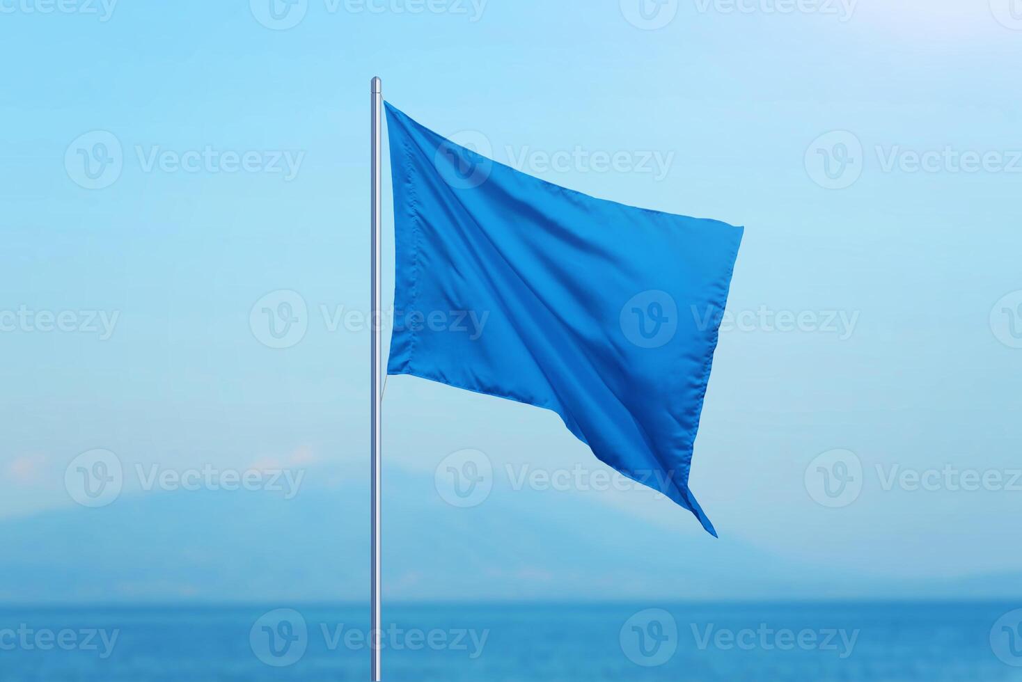 Blue flag with the sea in the background. Beaches meeting high standards are marked with a blue flag, symbolizing quality and safety. Ideal for travel and tourism photo