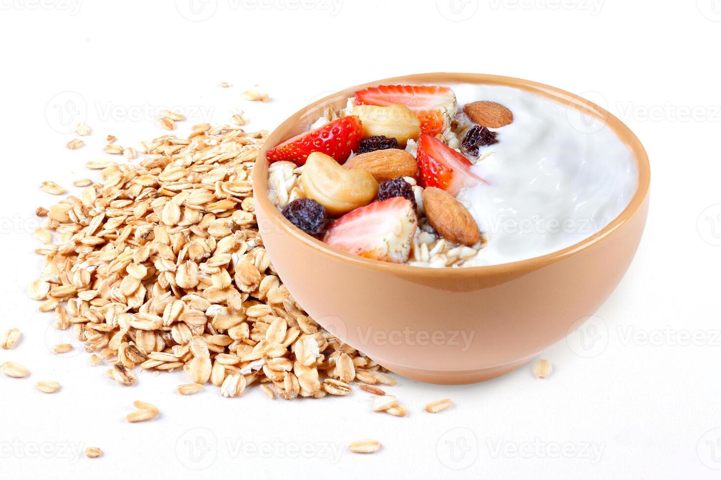 natural yogurt with oats, strawberries and nuts in ceramic bowl isolated on white background top view photo