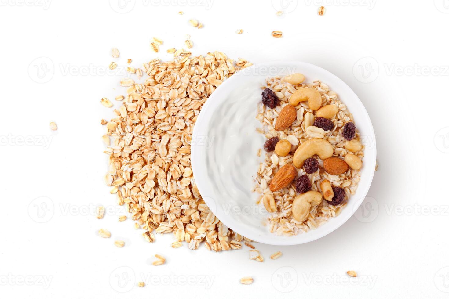 natural yogurt with oats and nuts in ceramic bowl top view isolated white background photo