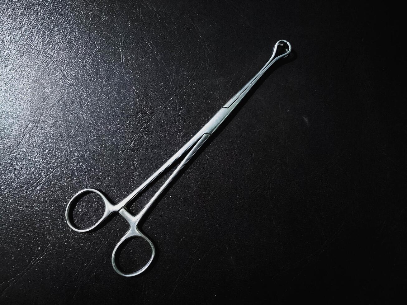 Allis Tissue Forceps, Surgical Instrument Isolated on the black Background photo