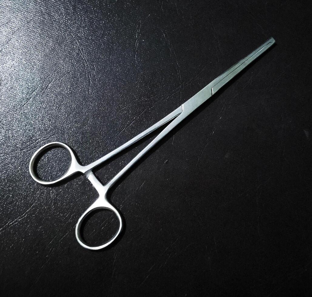 scissors to open stitches on the suture scar photo