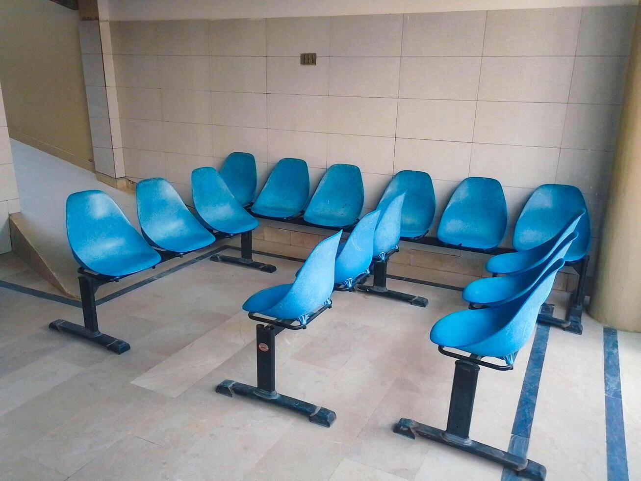 Arrangement of Blue chairs for sitting patient waiting in the hospital photo