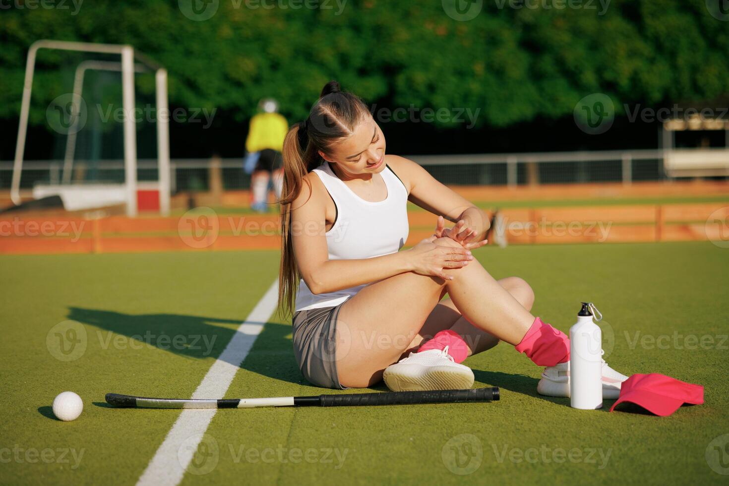 girl hockey player plays field hockey on a sunny day, a hockey player was injured in a game of field hockey, sports injuries photo
