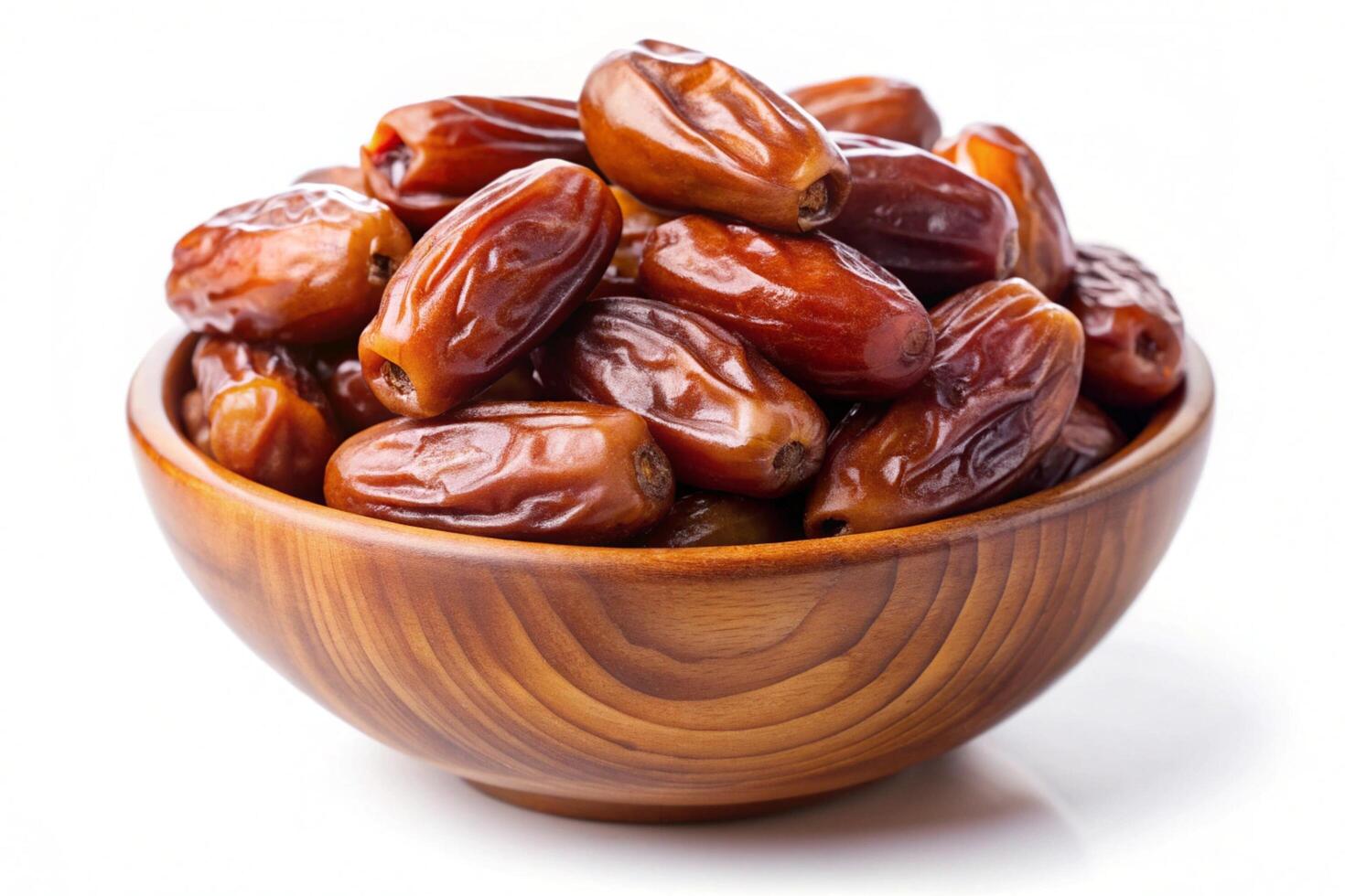 Dates in wood bowl isolated on white background photo