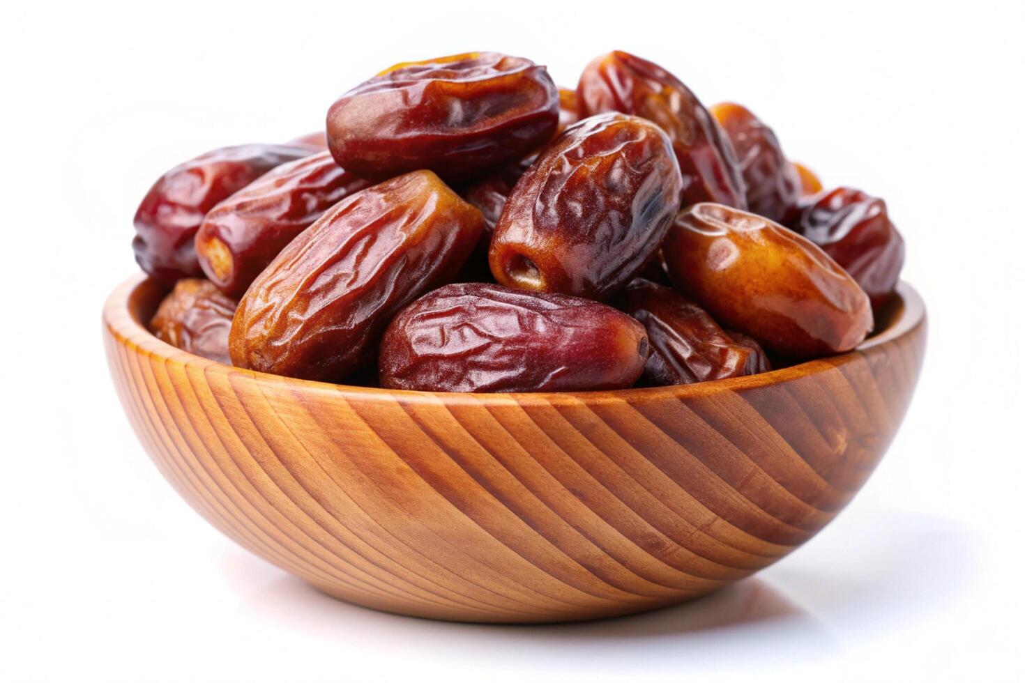 Dates in wood bowl isolated on white background photo