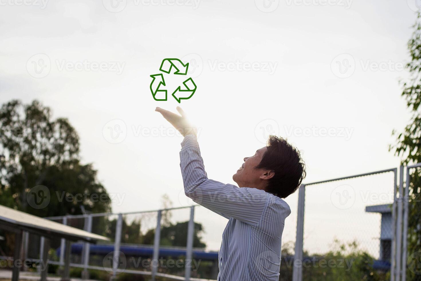 Renewable energy concept, environmentally friendly and sustainable development. People holding recycling symbol on virtual screen photo