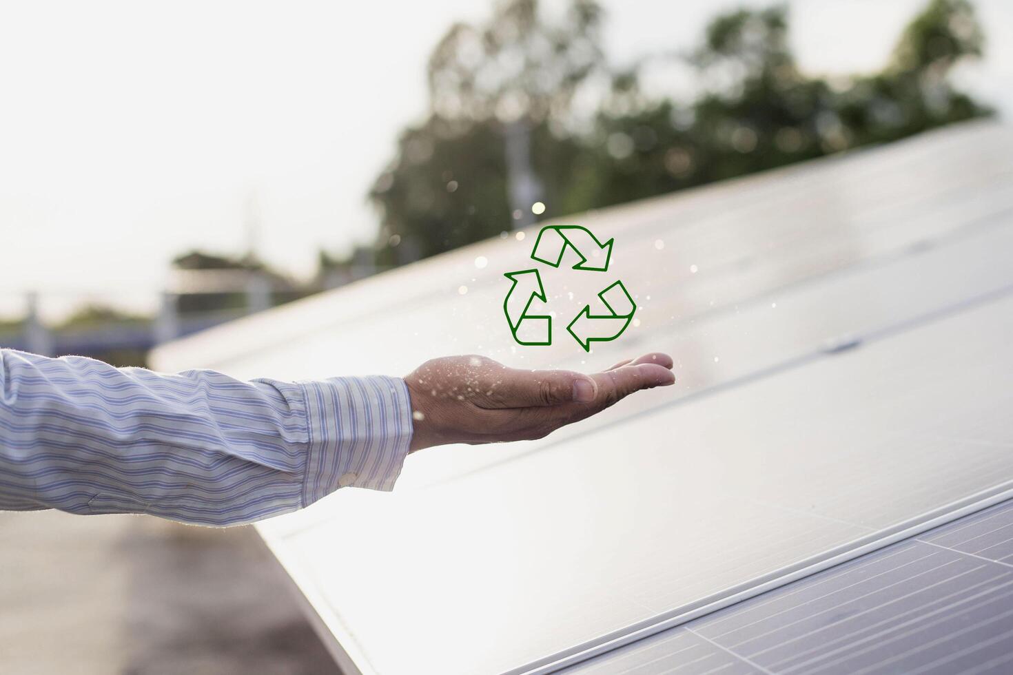 Renewable energy concept, environmentally friendly and sustainable development. People holding recycling symbol on virtual screen photo