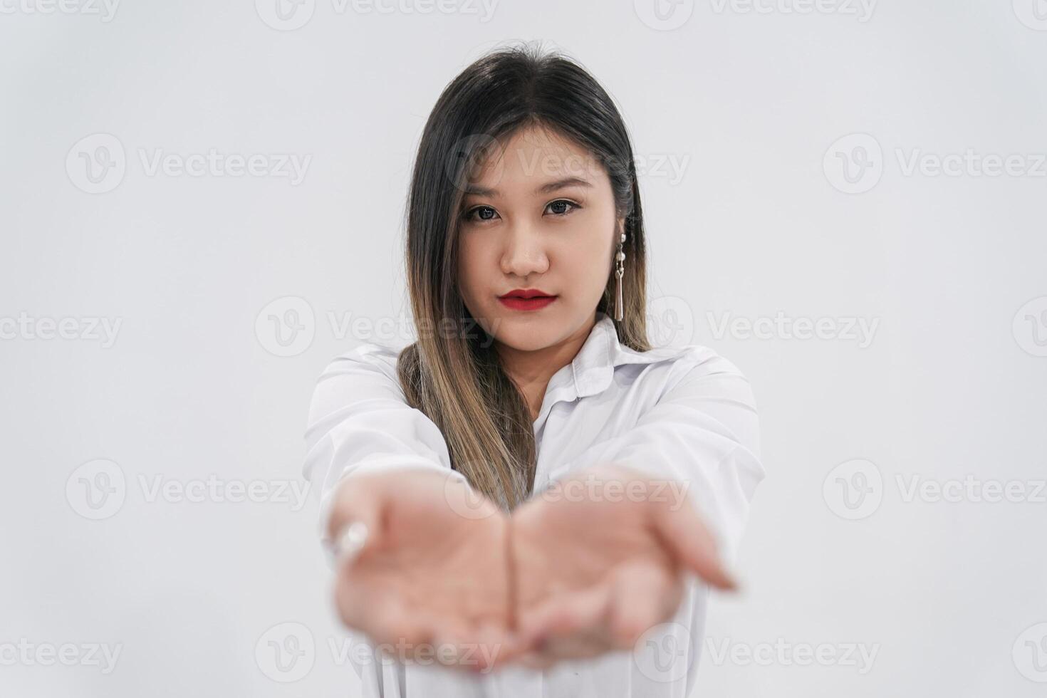 Empty thing in young Asian woman s two hands are raised up in front of camera for any presenting products or wording advertisements. photo