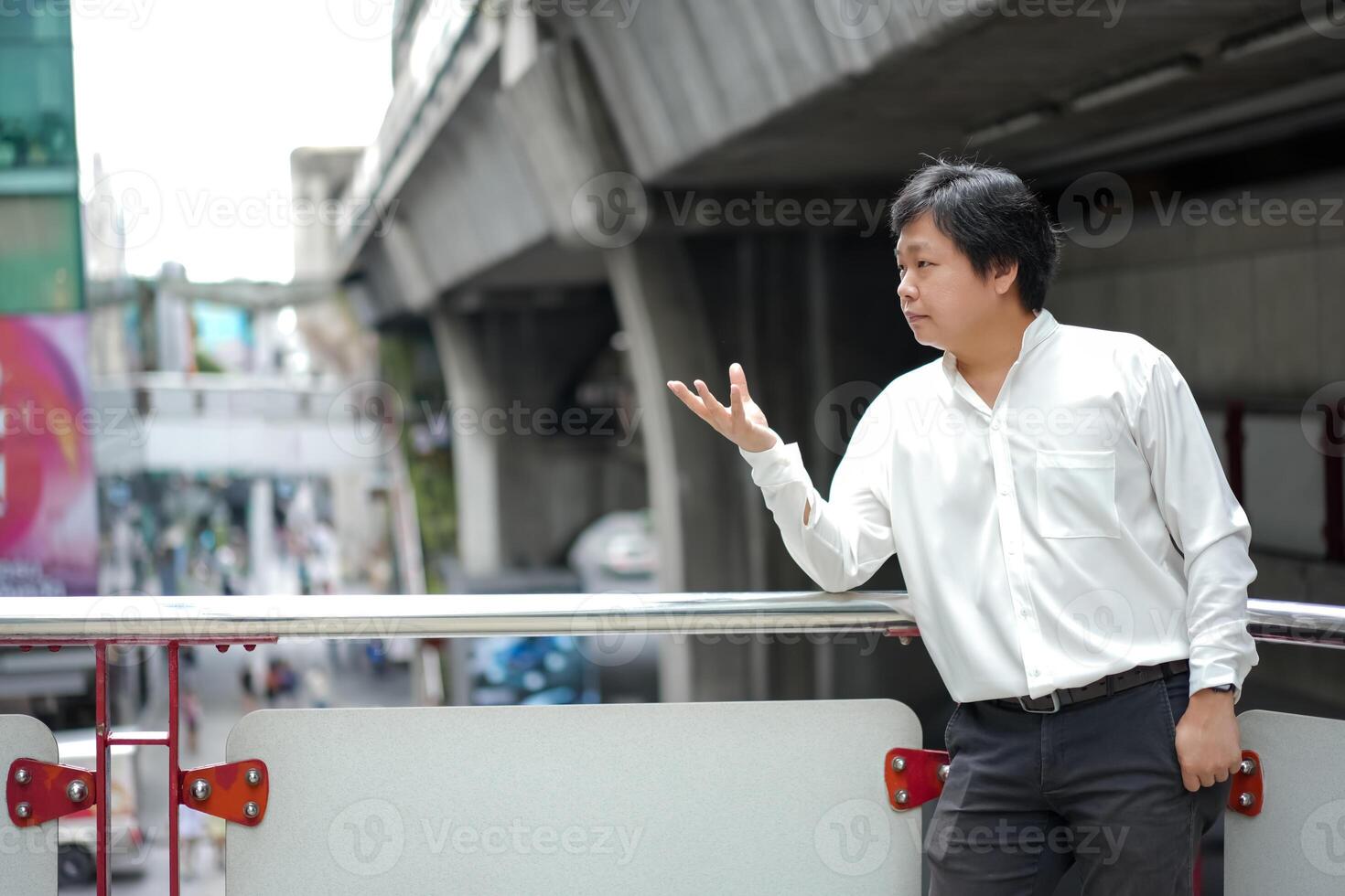 Black hair man is raising and lifting one s hand with empty thing on it. photo