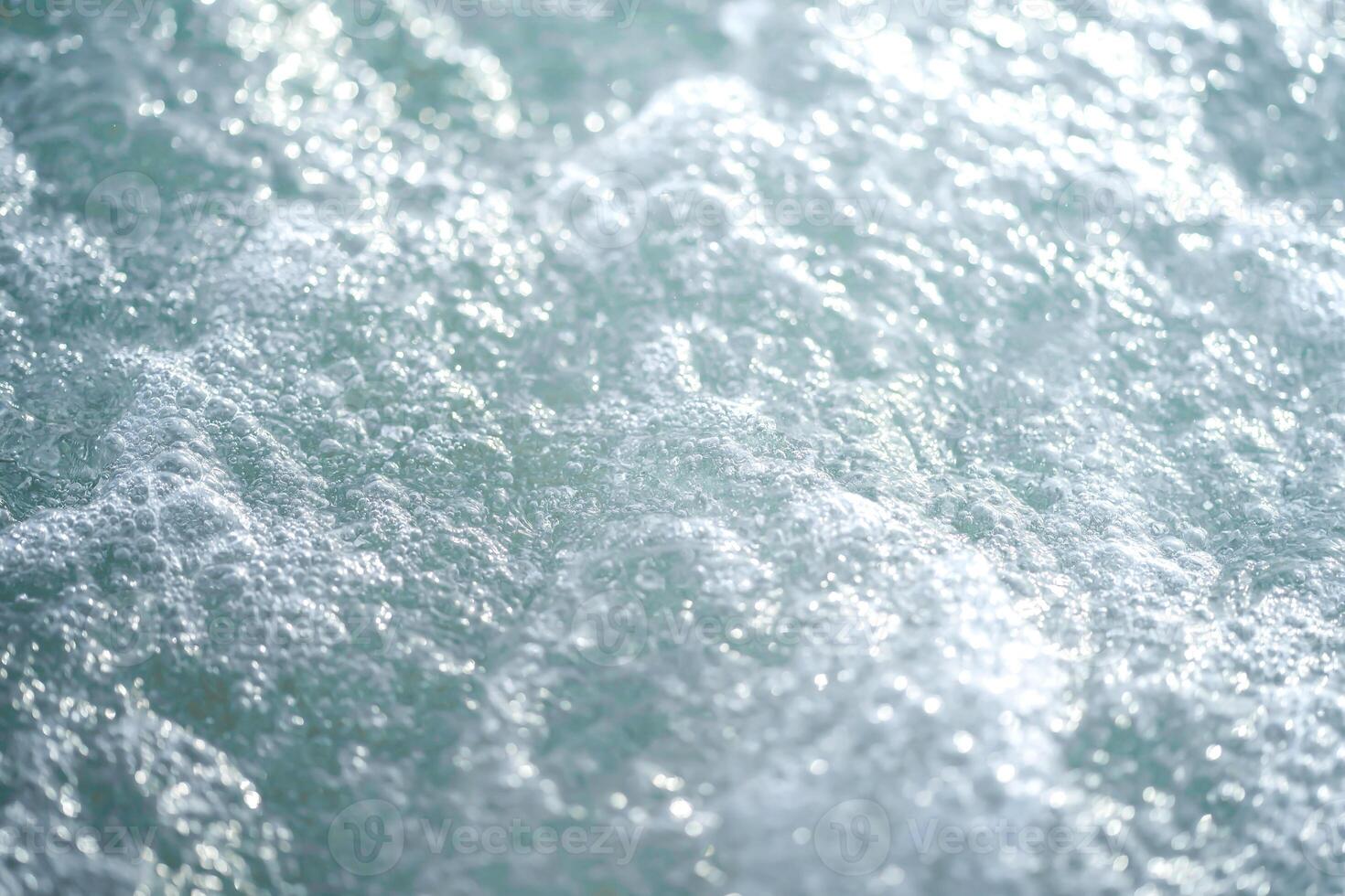 Background of closing up the bubble on surface sea wave on Kata beach at Phuket Thailand in afternoon time. photo