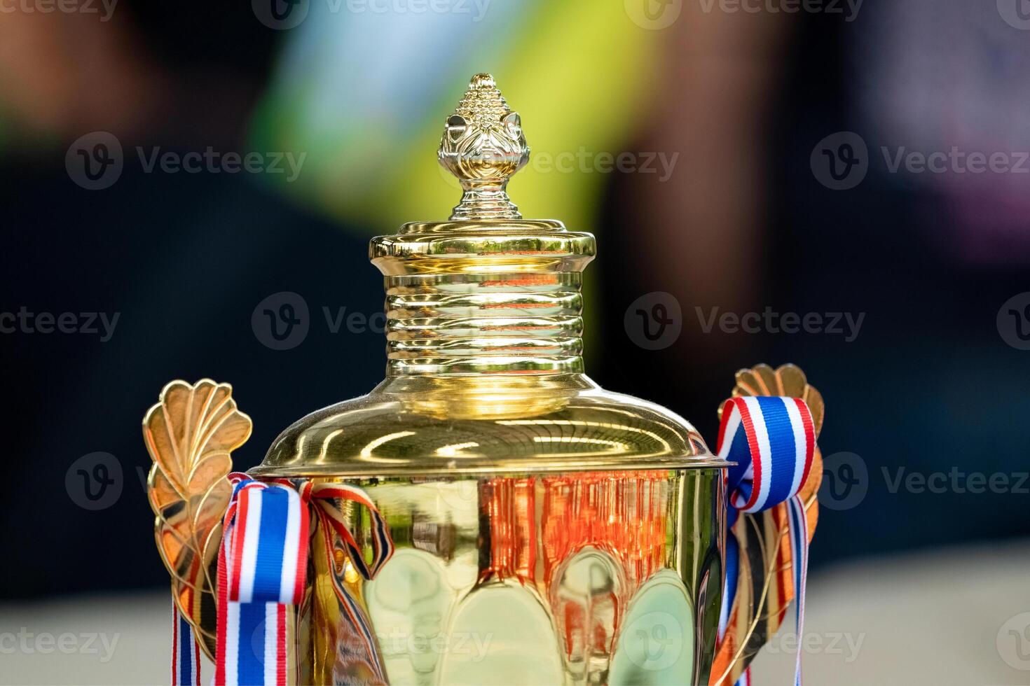 a golden shiny trophy is awarded to the winner of Thailand's school football tournament. photo