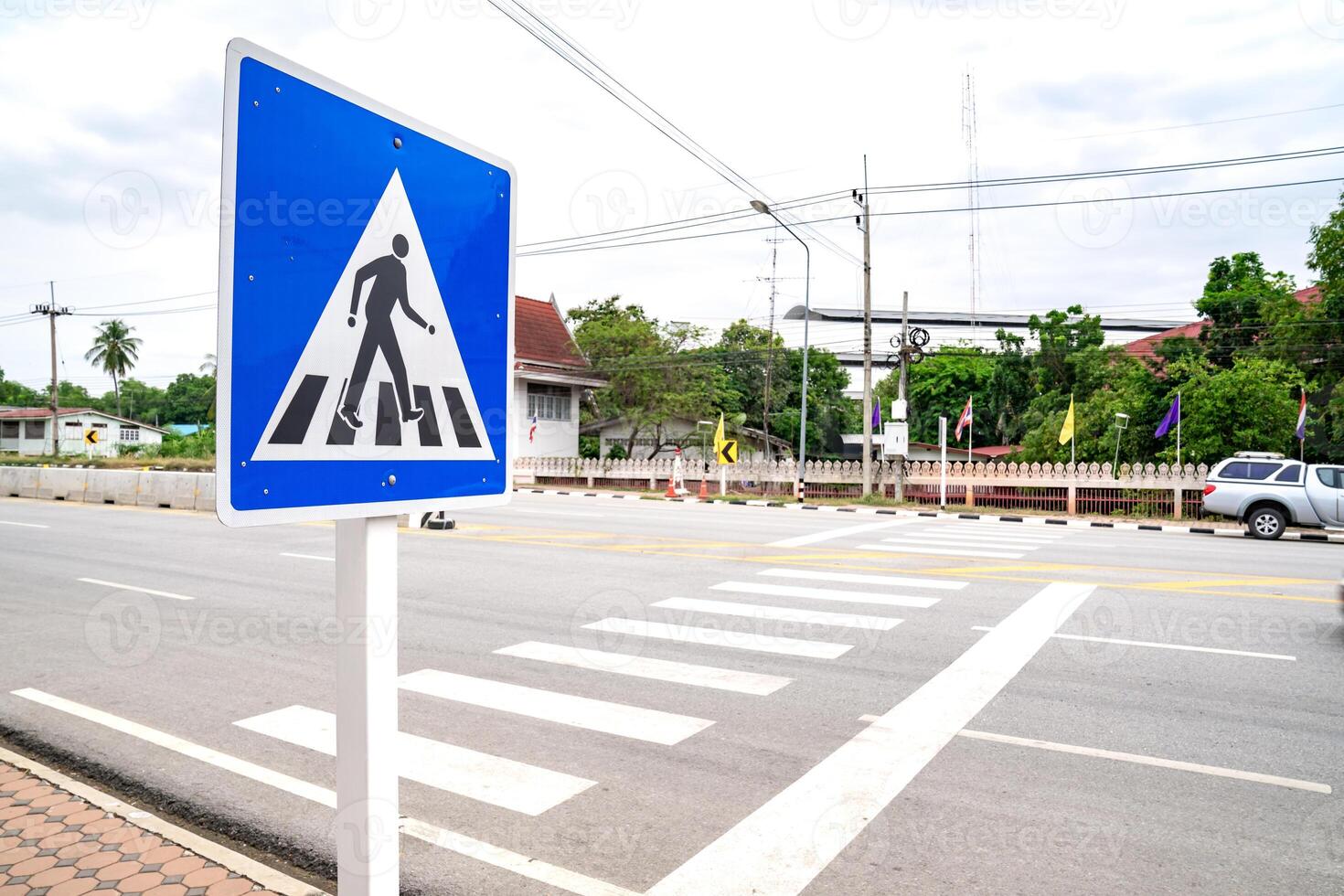 Empty people and passenger on crosswalk or zebra sign on the road in rural areas in Uthai Thani Province, Thailand, with local people building and environment. photo