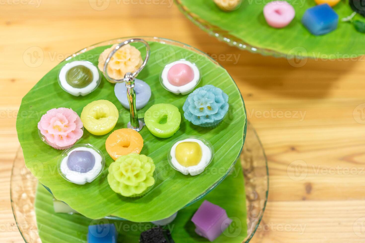 Varieties traditional colorful Thai desserts set NamDokMai steaming flour PiekPoon black custard, LeumKluen coconut custard steaming bean, KanomChan layer pudding cake photo