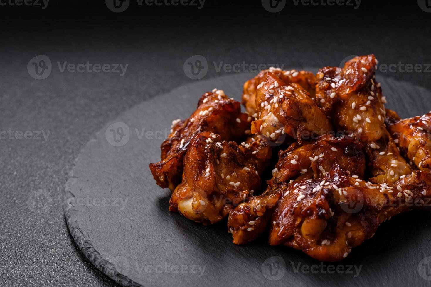 Delicious crispy baked chicken wings in teriyaki sauce photo