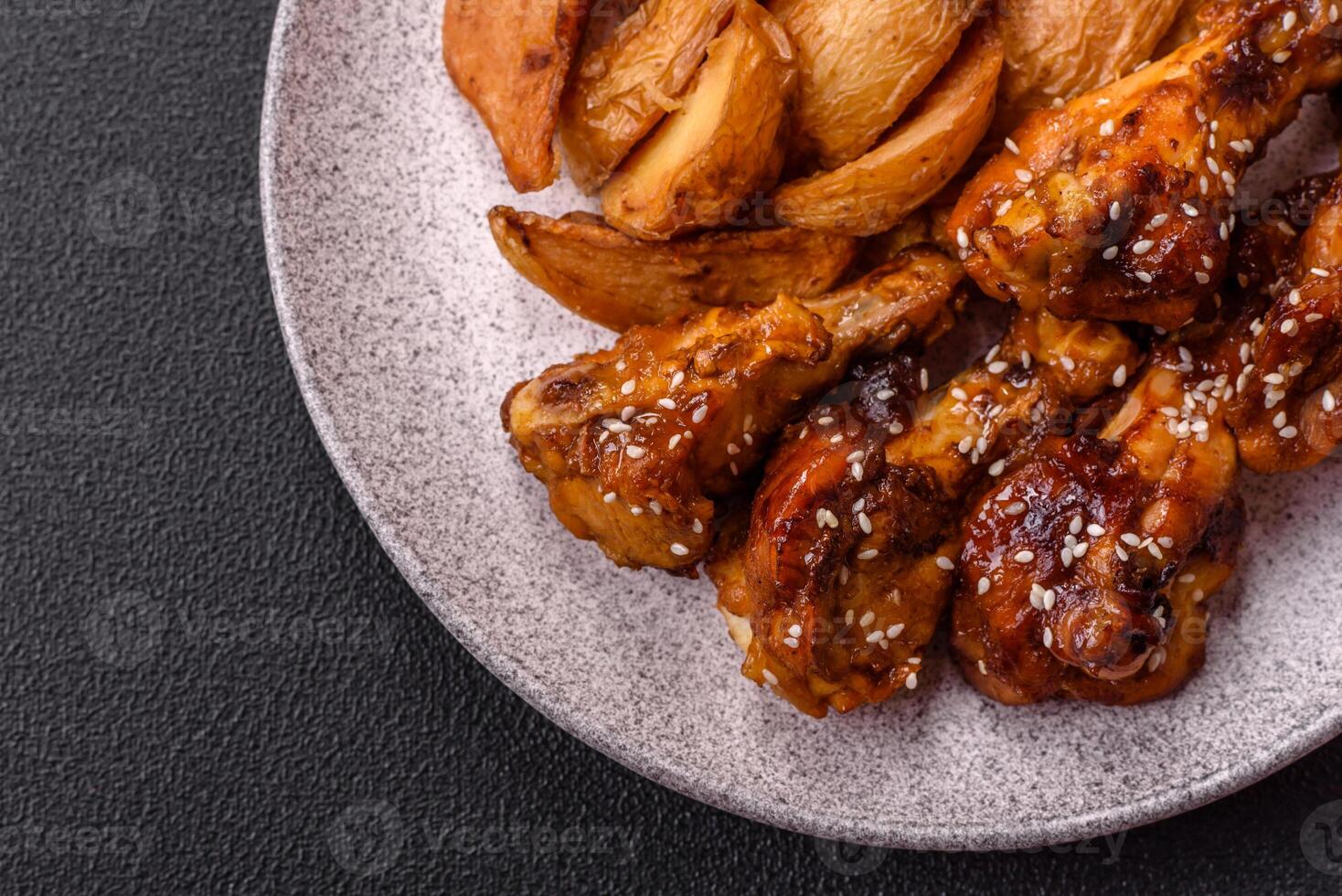 Delicious crispy baked chicken wings in teriyaki sauce photo