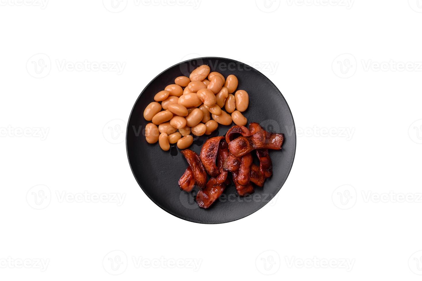 Fried sausages sliced with salt and spices as an ingredient for an English breakfast photo