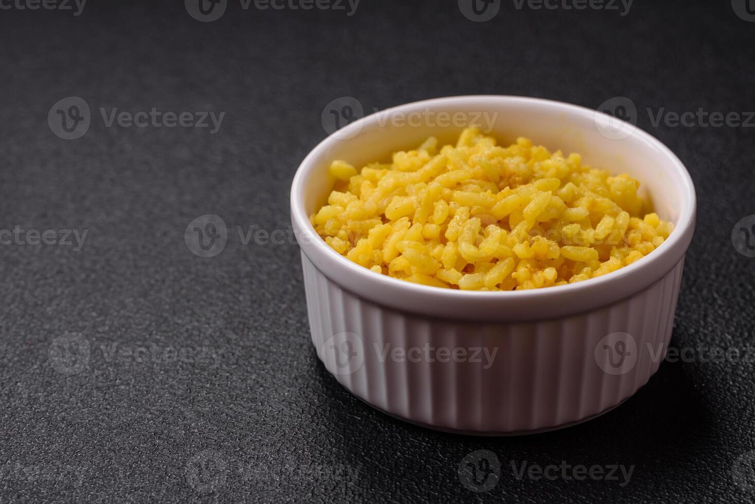 Delicious boiled yellow rice with turmeric, salt and spices photo