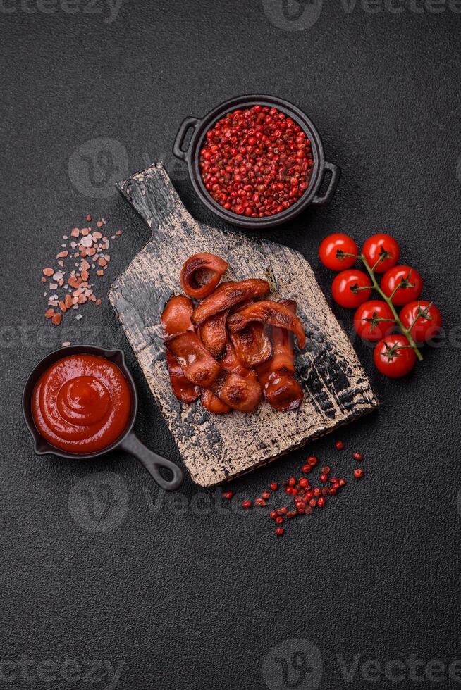 Fried sausages sliced with salt and spices as an ingredient for an English breakfast photo