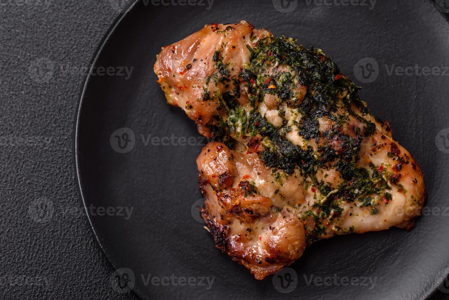 Grilled boneless chicken thigh with salt, spices and herbs photo
