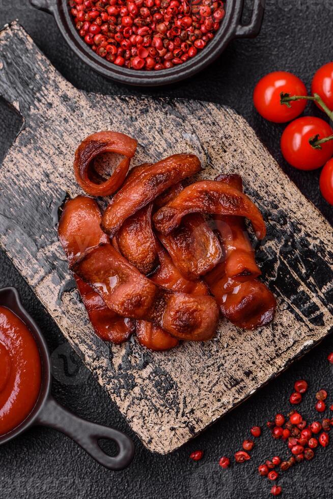Fried sausages sliced with salt and spices as an ingredient for an English breakfast photo