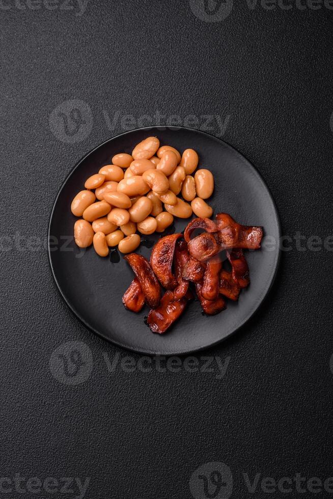 Fried sausages sliced with salt and spices as an ingredient for an English breakfast photo