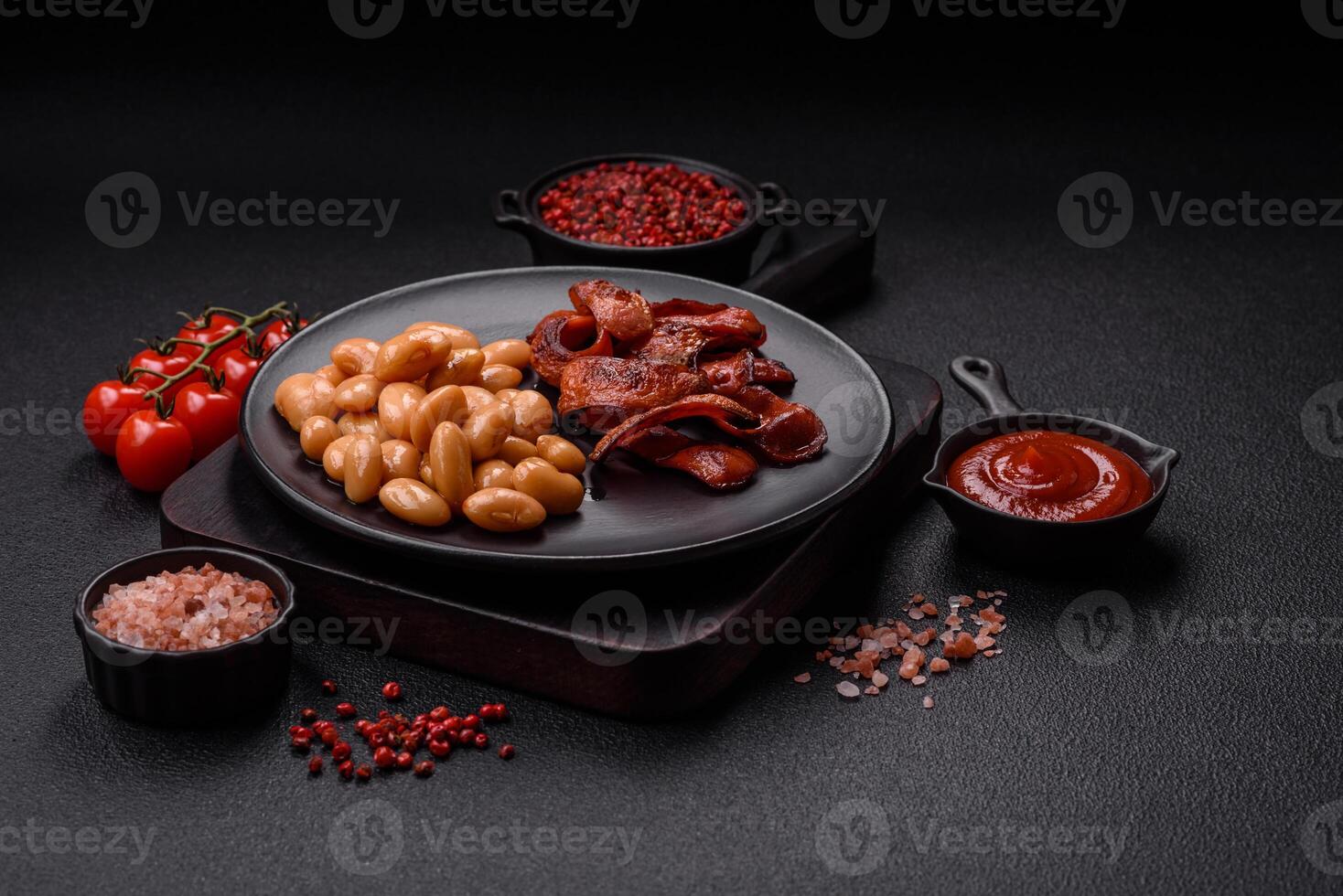 Fried sausages sliced with salt and spices as an ingredient for an English breakfast photo
