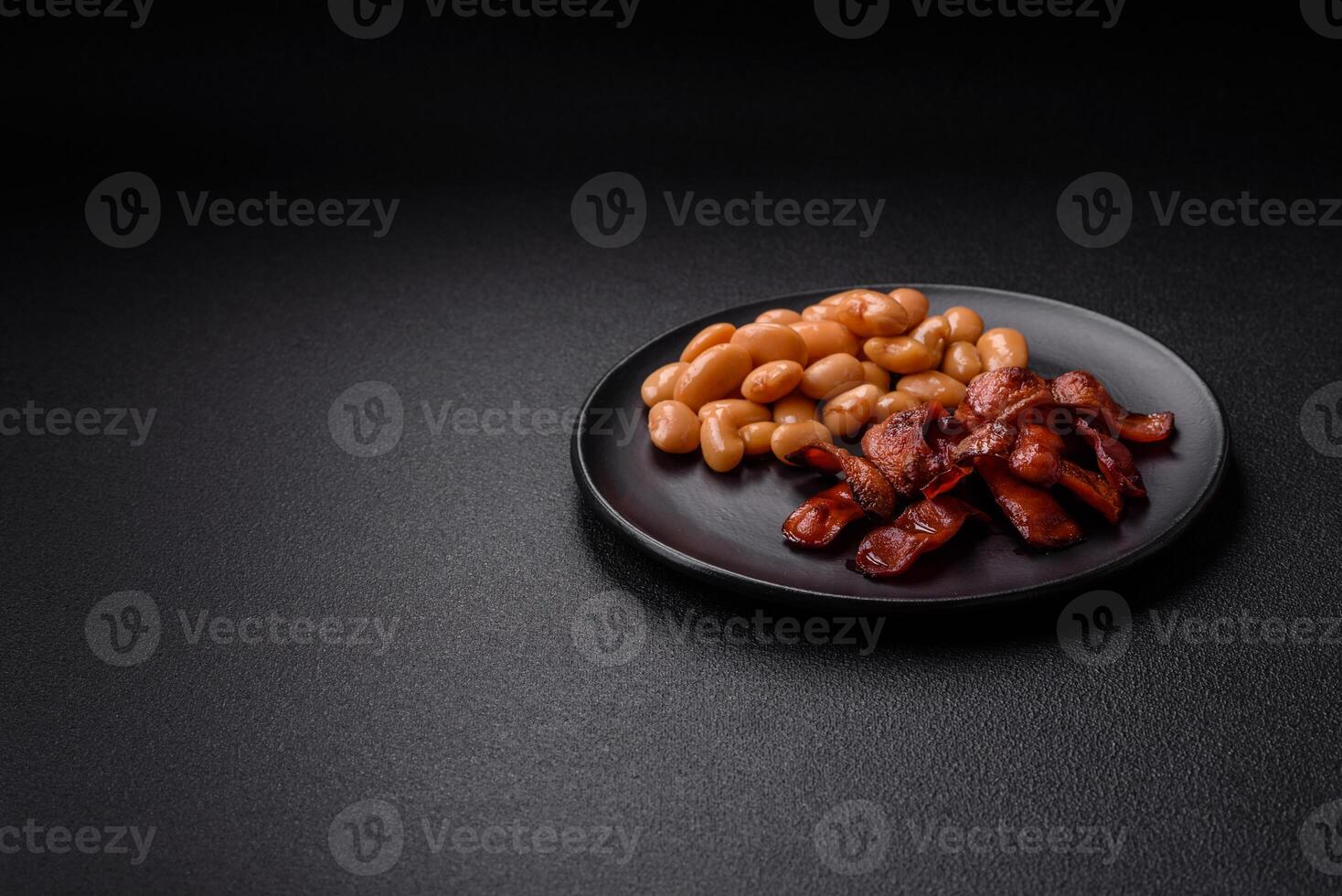 Fried sausages sliced with salt and spices as an ingredient for an English breakfast photo