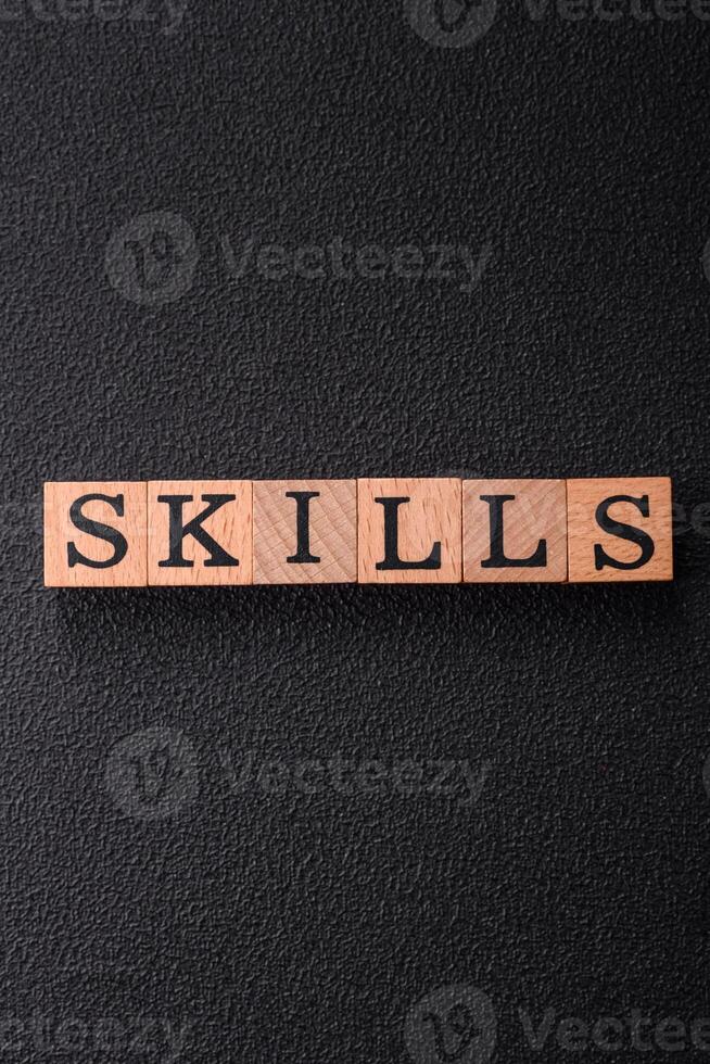The inscription Skills made of wooden cubes on a plain background photo