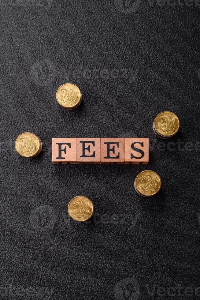 Inscription Fees with wooden cubes, conceptual background with copy space photo