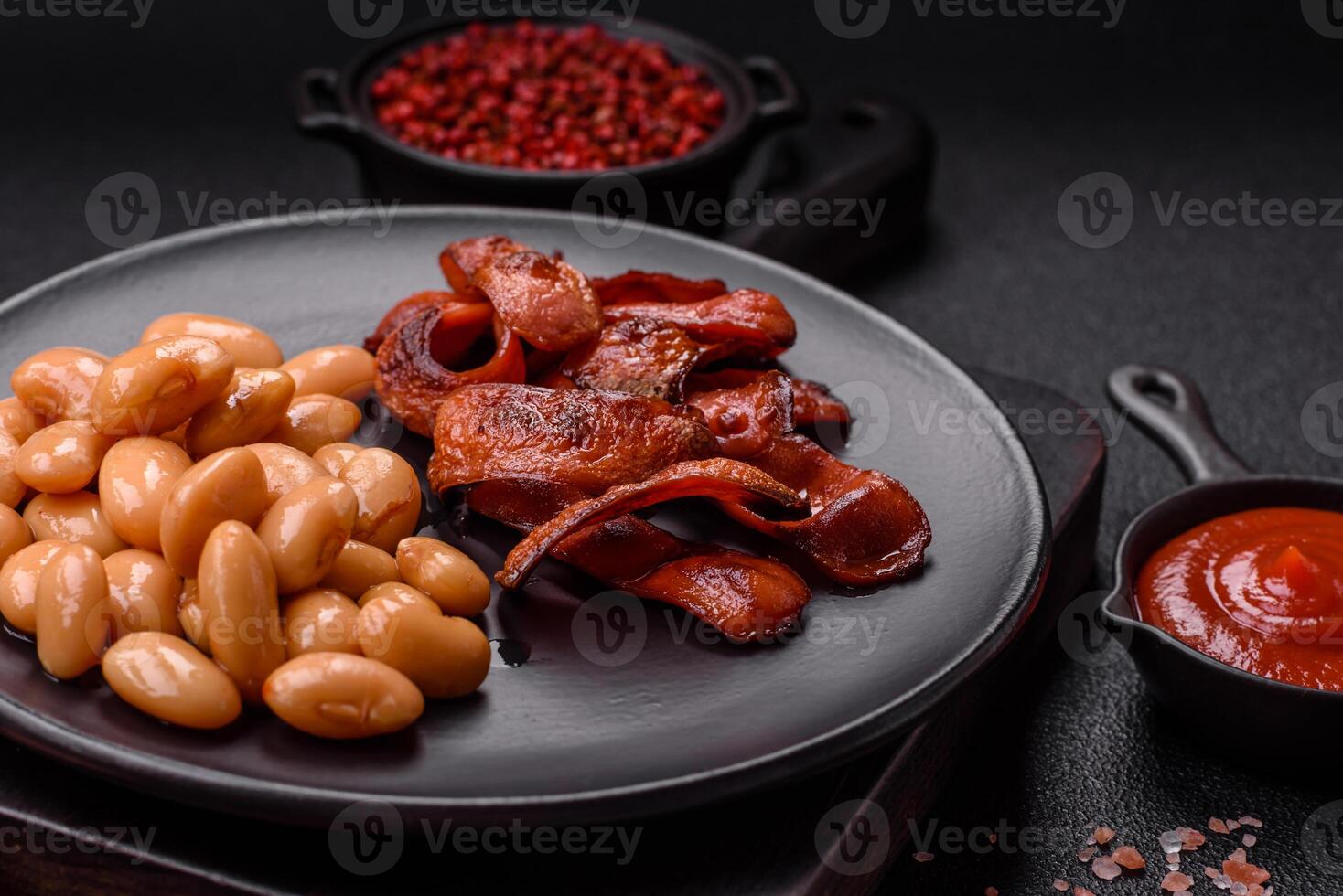 Fried sausages sliced with salt and spices as an ingredient for an English breakfast photo