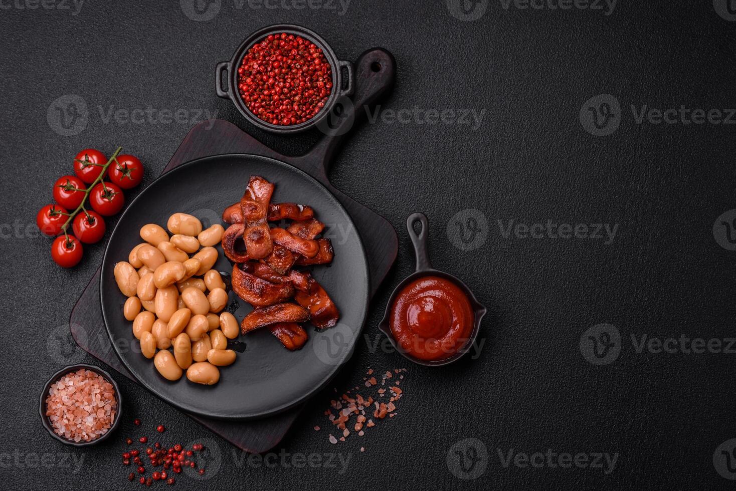 Fried sausages sliced with salt and spices as an ingredient for an English breakfast photo