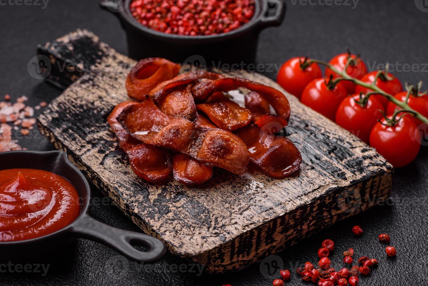 Fried sausages sliced with salt and spices as an ingredient for an English breakfast photo